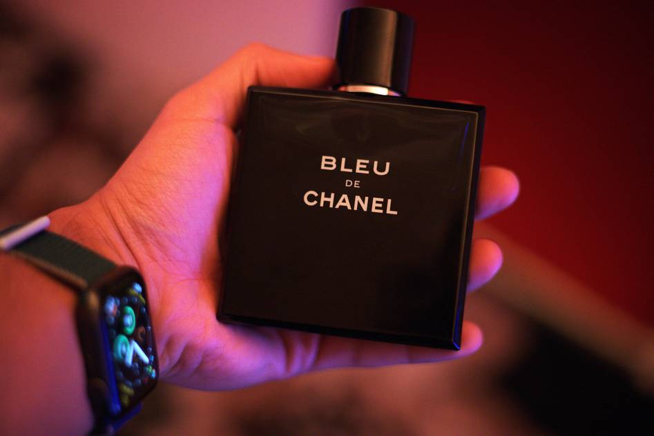 Man grooming with aftershave products on a modern bathroom counter